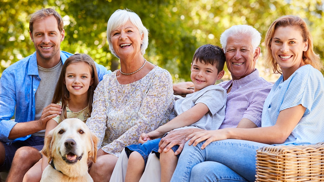 Family smiling outside